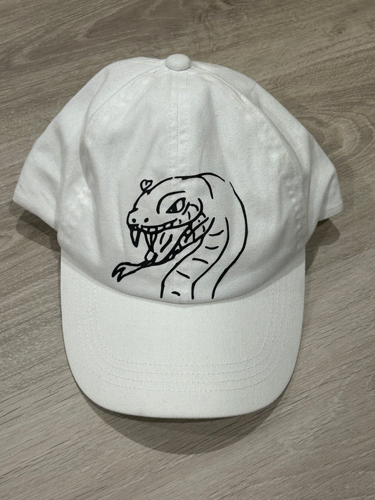 White hat with their child's drawing on it